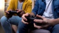 Two multiethnic teenage boys playing computer games at home, hands close-up Royalty Free Stock Photo