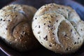 Two multigrain buns with sesame seeds and flaxseed on a brown plate Royalty Free Stock Photo