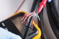 Two multimeter probes checking quality of network wiring closeup