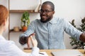 Two multiracial business partners handshaking focus on african-american employee Royalty Free Stock Photo