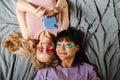 Two multiracial girls in eye patches taking selfie on mobile phone Royalty Free Stock Photo