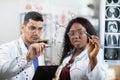 two multiracial scientists doctors, writing on the wall and looking at chemical formulas Royalty Free Stock Photo