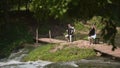 Two musicians Pianist and bandurist playing on the rocks at waterfall