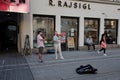 Two musicians play the violin on the Altstadt square in the city center of Innsbruck.