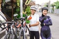 two muslim female cyclist with their road bicycle on a rack thumb up Royalty Free Stock Photo