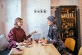 Two Muslim women in cafe, friends meeting Royalty Free Stock Photo