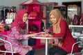 Two Muslim Hijab woman reading a magazine sitting inside their fashion store Royalty Free Stock Photo