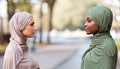 Two Muslim Women Enemies Standing Separately Posing Outdoors, Side-View Portrait Royalty Free Stock Photo