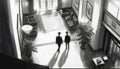 Two mysterious men in black walking in a hotel lobby. Generative AI Royalty Free Stock Photo