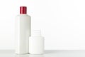Two nameless plastic bottles of white color from under a cosmetic product on a white background with place for text