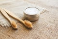 Two natural bamboo toothbrushes and kaolin dentifrice on rustic burlap background with copy space. Sustainable lifestyle and