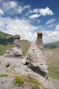 Two natural weathered rocks, blue sky with clouds