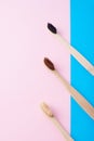 Two natural wooden toothbrushes on a blue and pink color background, flat lay top view. Concept of zero waste and dental care Royalty Free Stock Photo