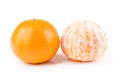 Two navel oranges one peeled one unpeeled