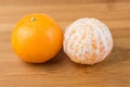 Two navel oranges one peeled one unpeeled Royalty Free Stock Photo