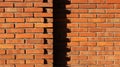 Two neighboring brick walls, with the shadows of the bricks of the first wall on the second one at the intersection point Royalty Free Stock Photo