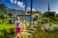 Two nepalese girls play in the garden of their home