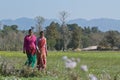 Two nepali tharu women walk in countryside, Nepal