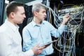 Two network support engineers administrating in server room Royalty Free Stock Photo