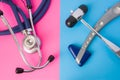 Two neurological rubber reflex hummers and medical stethoscope is in two colors background: blue and pink. Concept of neurological
