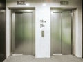 Two new elevators in the hotel. Material is stainless steel. Between the elevators there are floor signs and buttons for