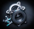 Two new hub bearings with spare mounting bolts, for a sports car. Black background, metal mesh Royalty Free Stock Photo