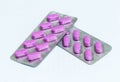 Two new packs of 10 pink oblong pills isolated on a white background Royalty Free Stock Photo