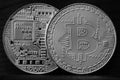 Two new silver physical bitcoins lies on dark wooden backgound, close up. High resolution photo. Cryptocurrency mining concep