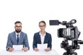 two newscasters with papers sitting in front of camera, Royalty Free Stock Photo