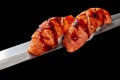 Nigirizushi with fried salmon and unagi sauce on thin blade of Japanese knife isolated on black Royalty Free Stock Photo