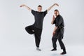 Two ninja pose and crutch on a gray background Royalty Free Stock Photo