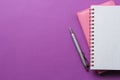 Two notebook and pen on a bright purple background. top view. office tools. space for text Royalty Free Stock Photo