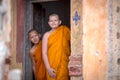 Two novices are looking in the temple of Buddhism in Thailand in