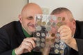 Two numismatists examines collection of coin Royalty Free Stock Photo