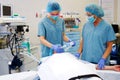 Two nurses with patient in operating room