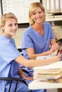 Two Nurses Working At Nurses Station Royalty Free Stock Photo