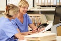 Two Nurses Working At Nurses Station Royalty Free Stock Photo