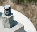 Two nuts threaded on bolt attached to cement block Royalty Free Stock Photo