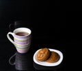 two oatmeal cookies lie on a white plate, next is a large stripe Royalty Free Stock Photo