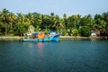 Two ocean fishing boats along the canal Kerala backwaters shore with palm trees between Alappuzha and Kollam, India Royalty Free Stock Photo