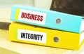 Two office folders with text BUSINESS INTEGRITY Royalty Free Stock Photo