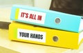 Two office folders with text its all in your hands Royalty Free Stock Photo