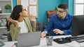Two office workers, a man and woman, sitting at a table, entangled in a heated argument at their workplace Royalty Free Stock Photo