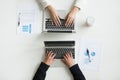 Two office workers typing on laptops, top close up view Royalty Free Stock Photo