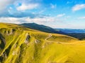 Two offroad cars parked on the mountain cliff in sunset near Travnik city in Bosnia and Herzegovina