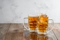 Two Oktoberfest beers splash on a wooden background