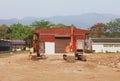 Two old backhoe loaders parked in front of the building Royalty Free Stock Photo