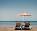 Two old beach chairs and sun umbrella Royalty Free Stock Photo