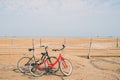 two old bikes at the beach in front of the sea Royalty Free Stock Photo