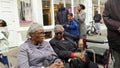 Two old black Caribbean ladies seated on a bench talking. London